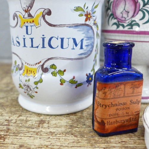 794 - A collection of Continental apothecary jars, bottles and a pot lid