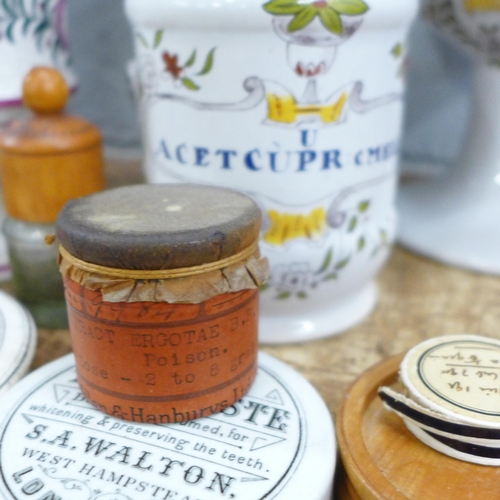 794 - A collection of Continental apothecary jars, bottles and a pot lid