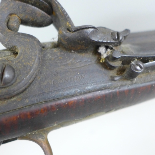 821 - A large flintlock pistol, marked London, a/f, 58cm **PLEASE NOTE THIS LOT IS NOT ELIGIBLE FOR IN-HOU... 