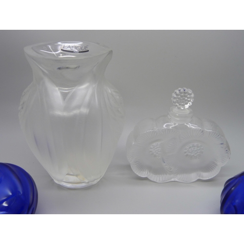 824 - A Lalique perfume bottle, a Lalique vase, 12.5cm, and two Lalique blue crystal perfume bottles, lack... 