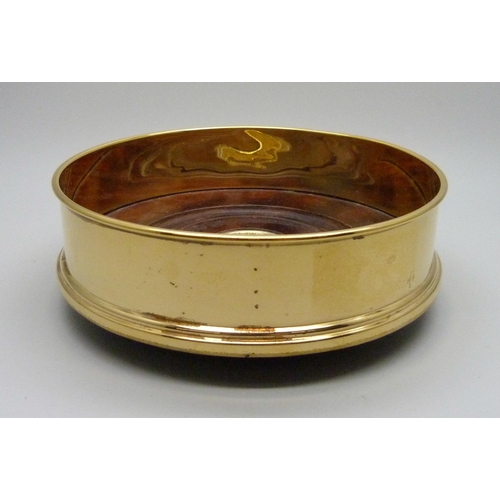 832 - A silver gilt bottle coaster