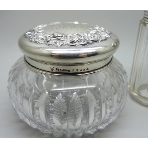 844 - Two silver topped glass dressing table pots, 34g of silver