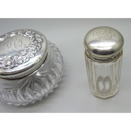 844 - Two silver topped glass dressing table pots, 34g of silver