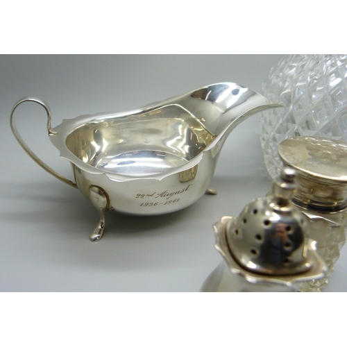 862 - Silver items; sauce boat, cruet set, silver mounted scent, shaker and salts jar, 241g of weighable s... 