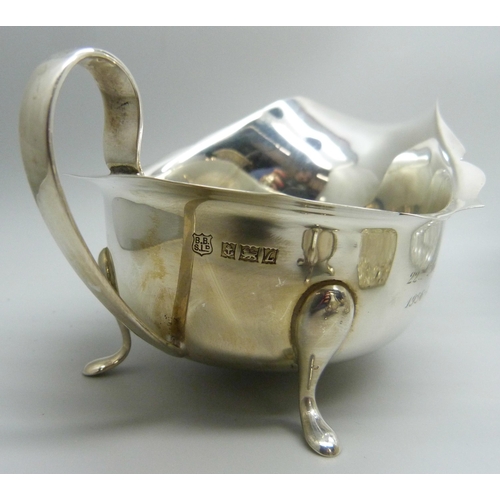 862 - Silver items; sauce boat, cruet set, silver mounted scent, shaker and salts jar, 241g of weighable s... 