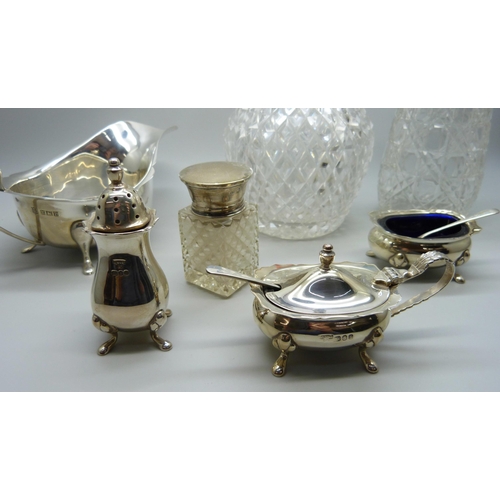 862 - Silver items; sauce boat, cruet set, silver mounted scent, shaker and salts jar, 241g of weighable s... 