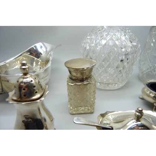 862 - Silver items; sauce boat, cruet set, silver mounted scent, shaker and salts jar, 241g of weighable s... 