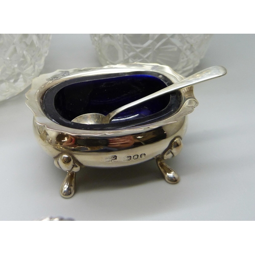 862 - Silver items; sauce boat, cruet set, silver mounted scent, shaker and salts jar, 241g of weighable s... 