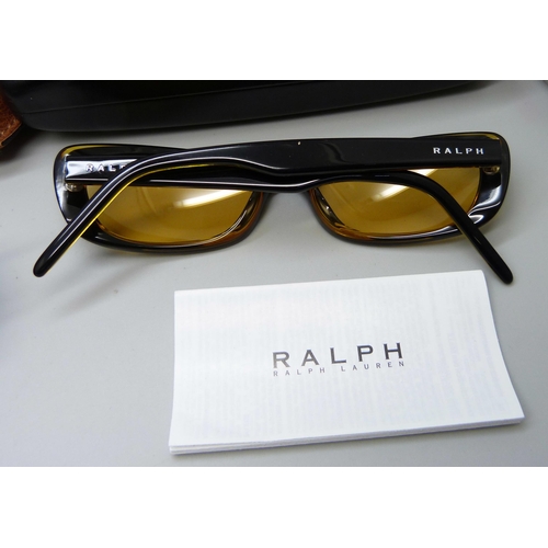 919 - A pair of Ray-Ban sunglasses and two pairs of Ralph Lauren sunglasses, all with cases