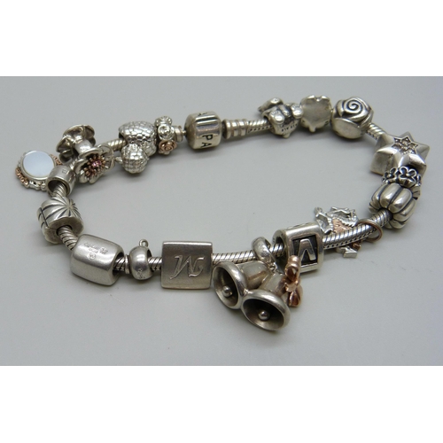 961 - A silver Pandora bracelet with eight Clogau charms, four Pandora charms and others