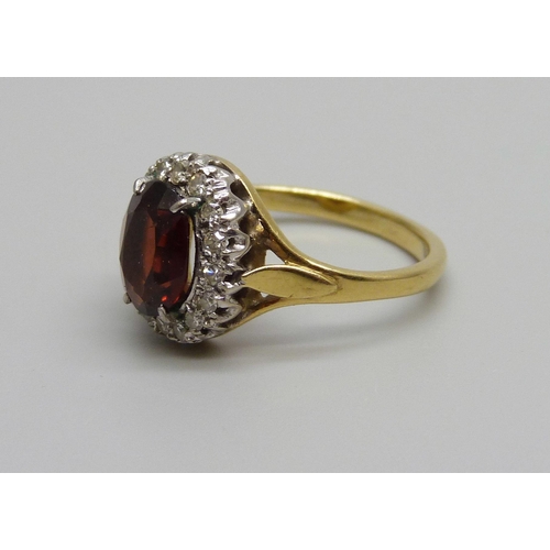 979 - An 18ct gold, garnet and diamond cluster ring, 4.3g, L/M