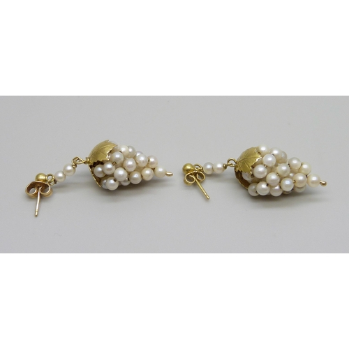 982 - A pair of yellow metal mounted pearl earrings, marked 18