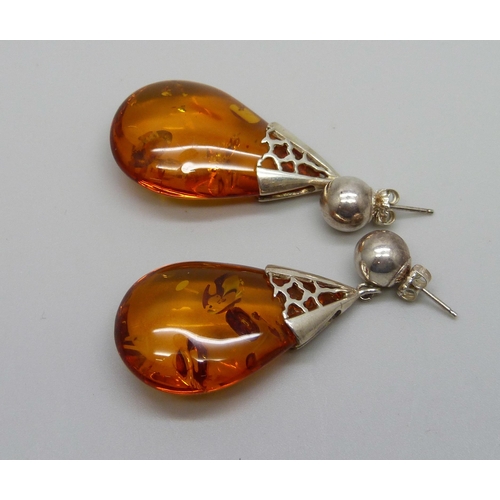 996 - A pair of large amber earrings, silver mounted, with butterflies