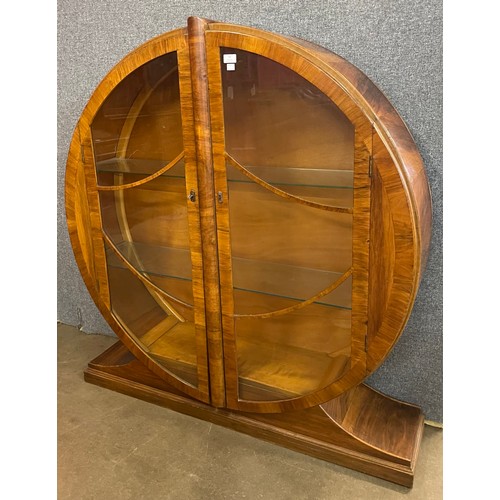 92 - An Art Deco walnut circular two door display cabinet