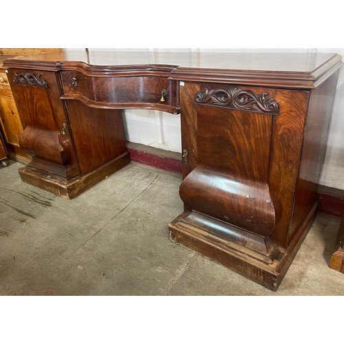 96 - A Victorian mahogany serpentine pedestal sideboard