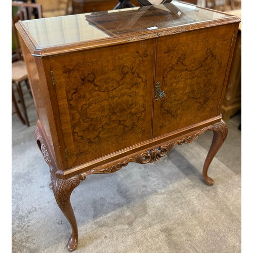 140 - A Queen Anne style figured walnut cocktail cabinet