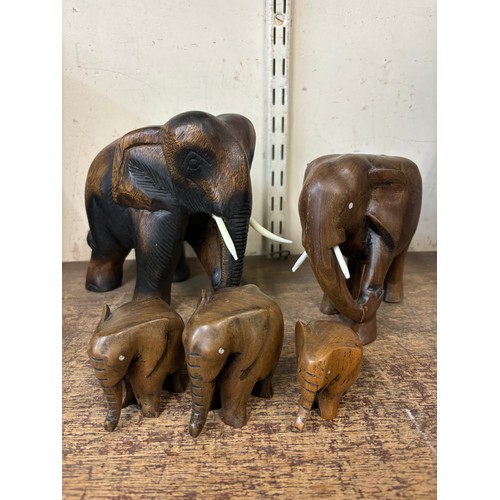 327 - Five African carved wooden elephants, with faux ivory tusks