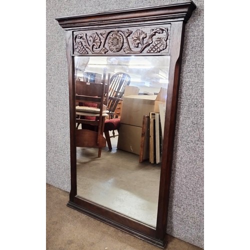 315B - A Jaycee carved oak framed mirror