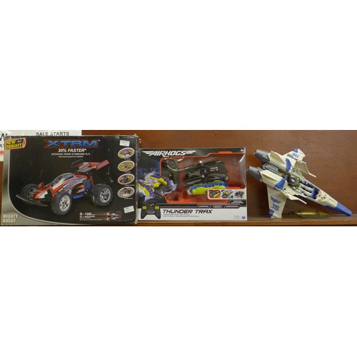 720 - An XTRM radio controlled Mighty Buggy, a Thunder Trax Air Hogs radio controlled tank/boat and a Buzz... 