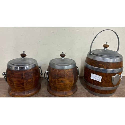 308 - Three oak biscuit barrel jars, with plated tops