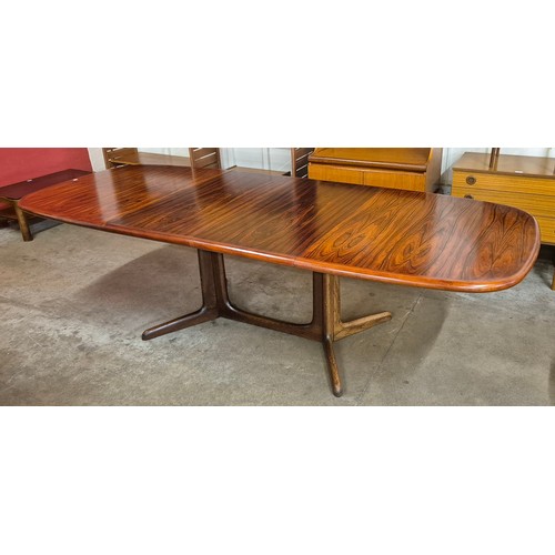 20 - A Danish simulated rosewood extending dining table