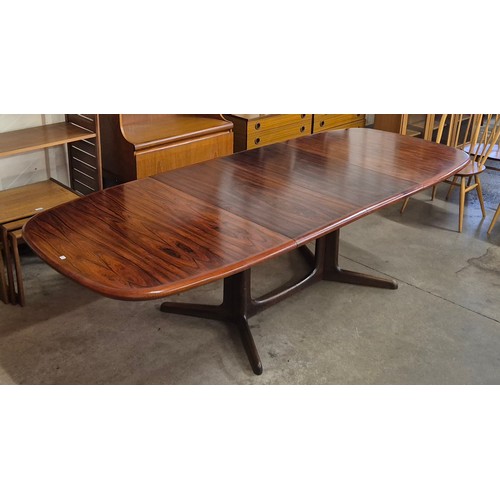 20 - A Danish simulated rosewood extending dining table