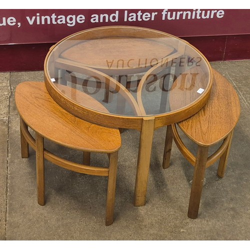 32 - A Nathan Trinity teak and glass topped circular nest of tables