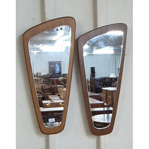 34 - A pair of teak asymmetrical framed mirrors