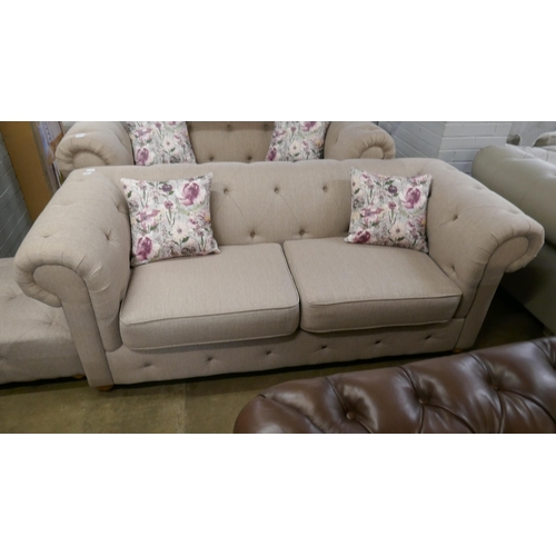 1350 - An oatmeal weave Chesterfield three seater sofa and footstool RRP £1379