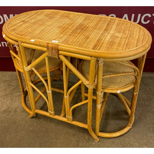 82 - A bamboo and rattan table and two chairs