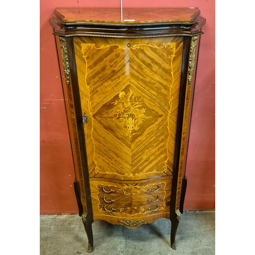 100 - A French Louis XV style marquetry inlaid walnut and ormolu mounted serpentine side cabinet