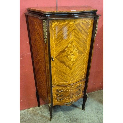 100 - A French Louis XV style marquetry inlaid walnut and ormolu mounted serpentine side cabinet