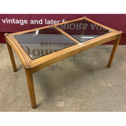 90 - An Ercol Golden Dawn elm and glass topped coffee table