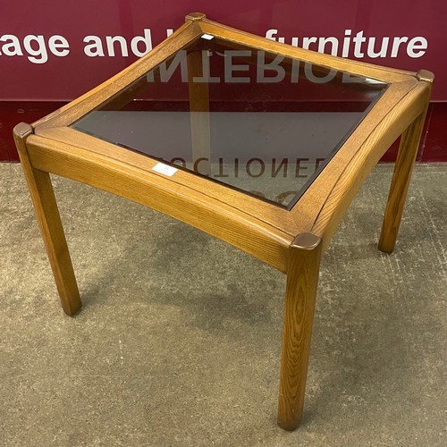 91 - An Ercol Golden Dawn elm and glass topped coffee table