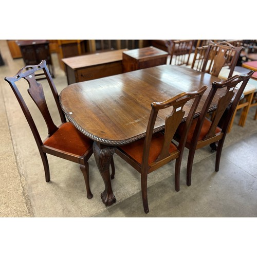 206 - An Edward VII Chippendale Revival carved mahogany extending dining table and four chairs