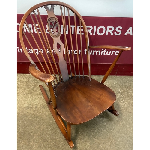 97A - An Ercol Golden Dawn elm and beech fleur de lys rocking chair