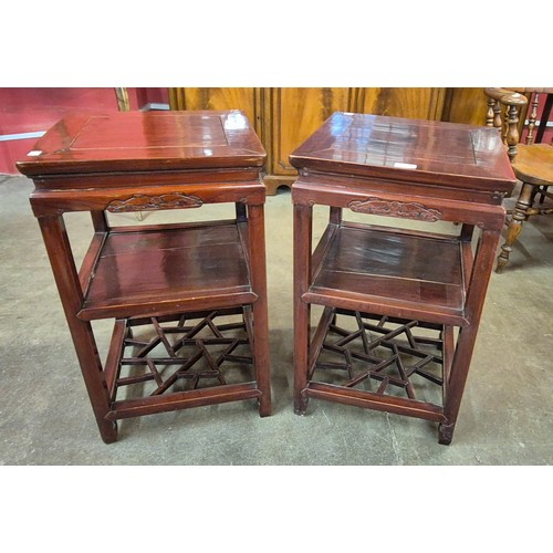 106 - A pair of 19th Century style Chinese hardwood two tier lamp tables