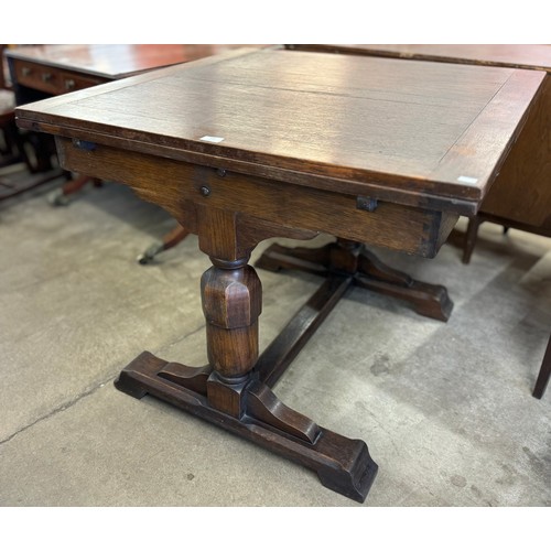 150 - An early 20th Century carved oak draw leaf dining table