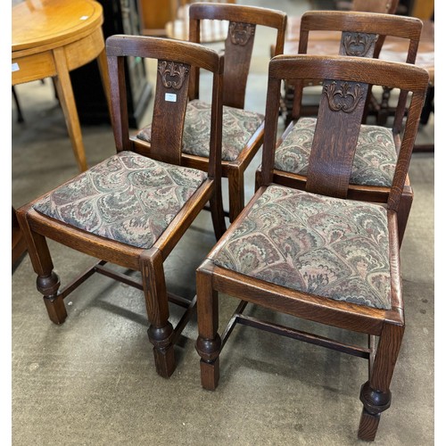 152 - A set of four early 20th Century carved oak dining chairs