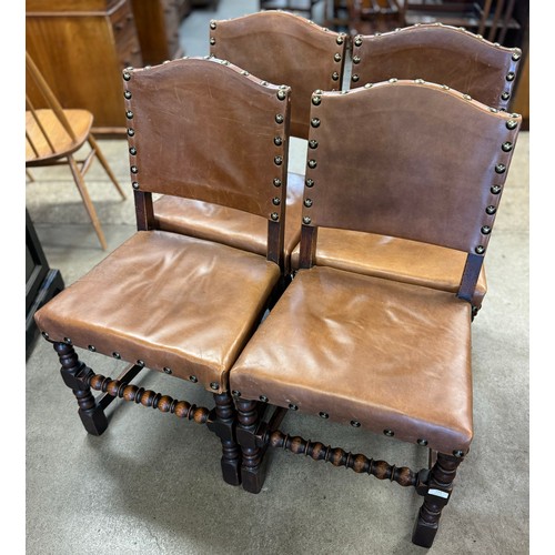 153 - A set of four early 20th Century oak and brown leather dining chairs