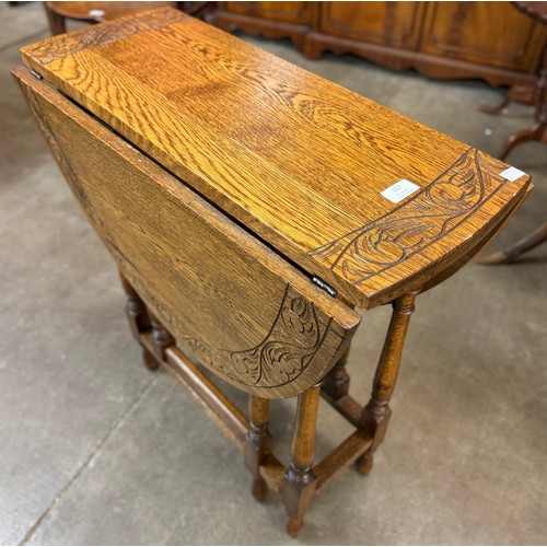 157 - An early 20th Century carved oak gateleg table