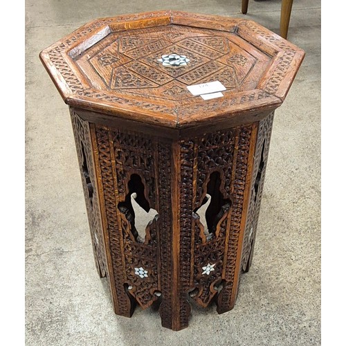 124 - A small Moorish carved hardwood and mother of pearl inlaid octagonal occasional table