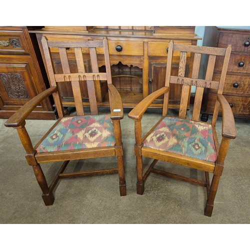 128 - A pair of early 20th Century oak elbow chairs