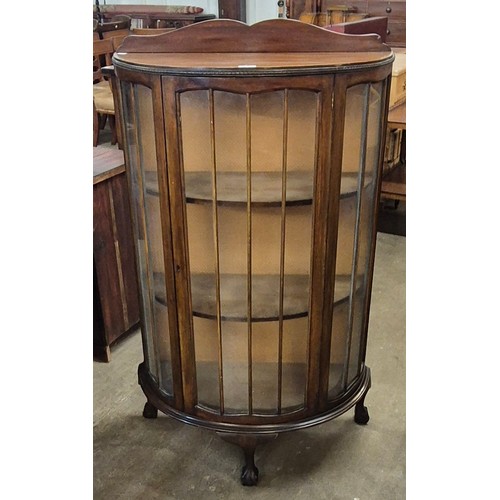 138 - An early 20th Century walnut bow front display cabinet