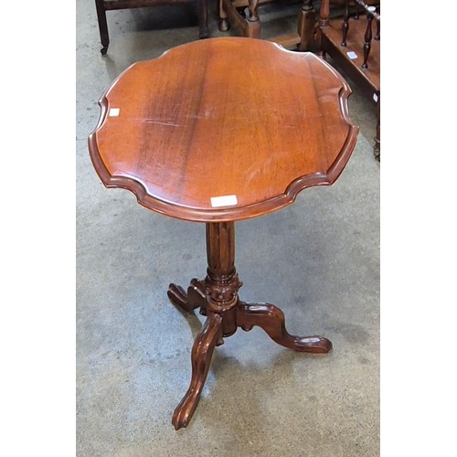 141 - A Victorian style carved mahogany tripod lamp table