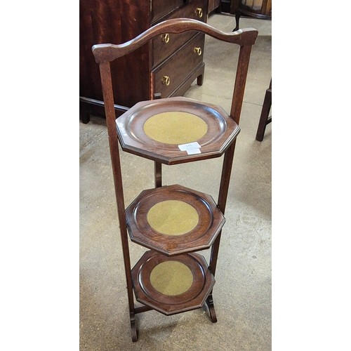 143 - An Edward VII mahogany octagonal three tier folding cake stand