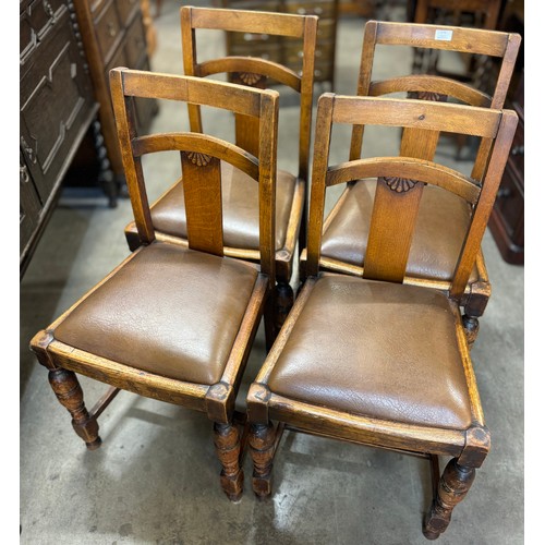 175 - A set of four early 20th Century carved oak dining chairs