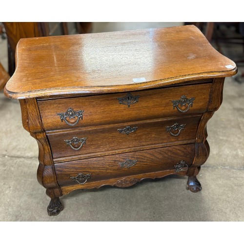 184 - A 19th Century style Dutch oak bombe shaped chest of drawers