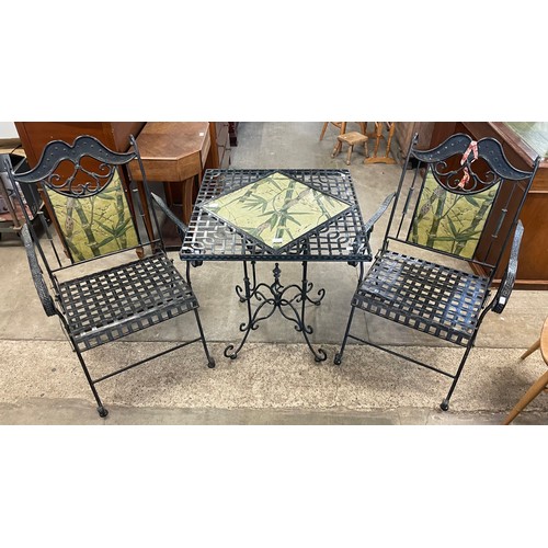 225 - A metal tiled top garden table and two chairs