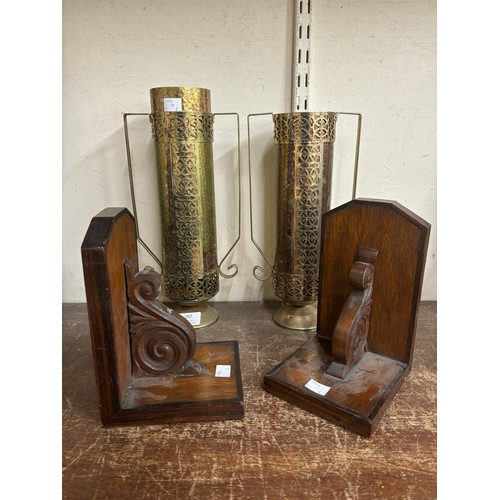 297 - Two hammered brass vases and a pair of mahogany bookends